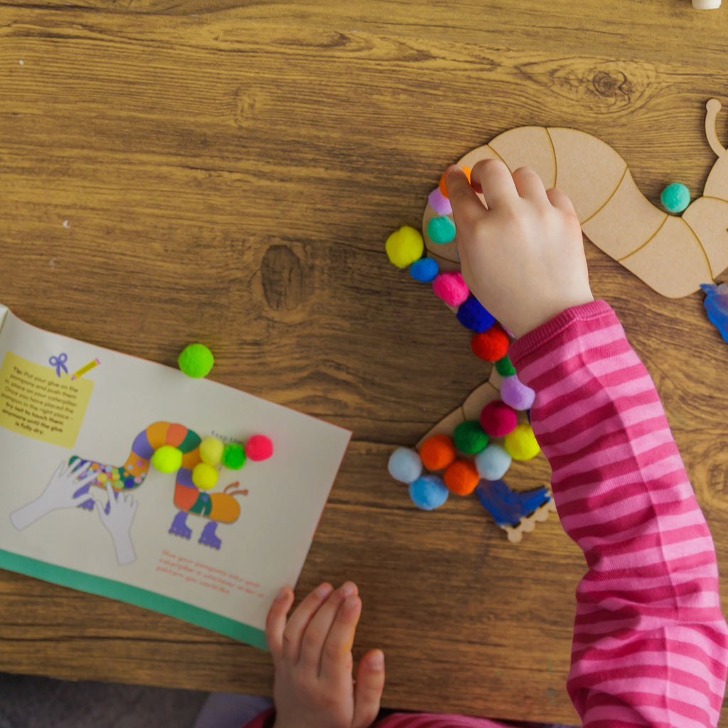 A girl following the easy steps in the instruction booklet to make her caterpillar project a success.