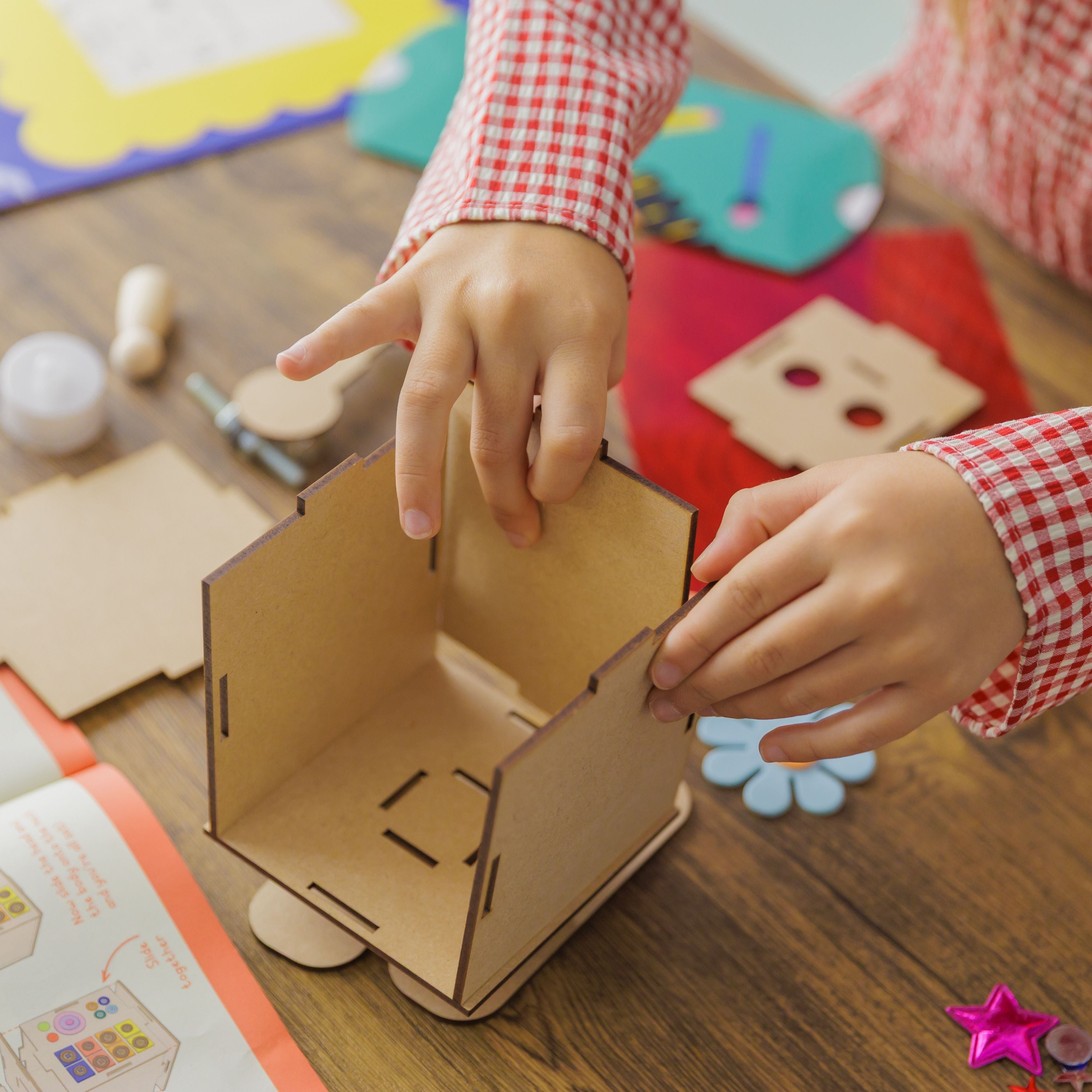 Child focused on building their own wooden robot, a hands-on activity that encourages problem-solving and creativity.