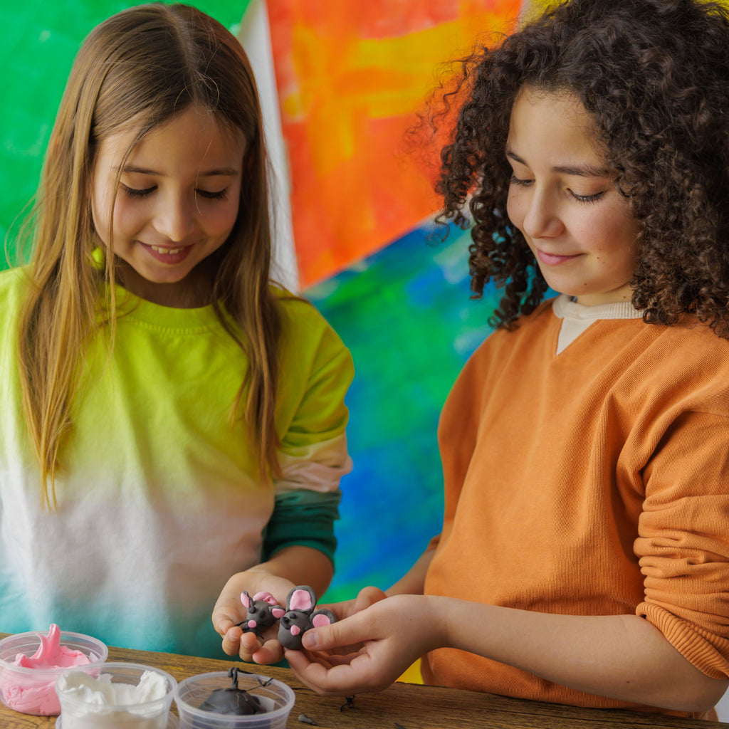 Two children playing with clay mice. Craft kit Dabble & Co.