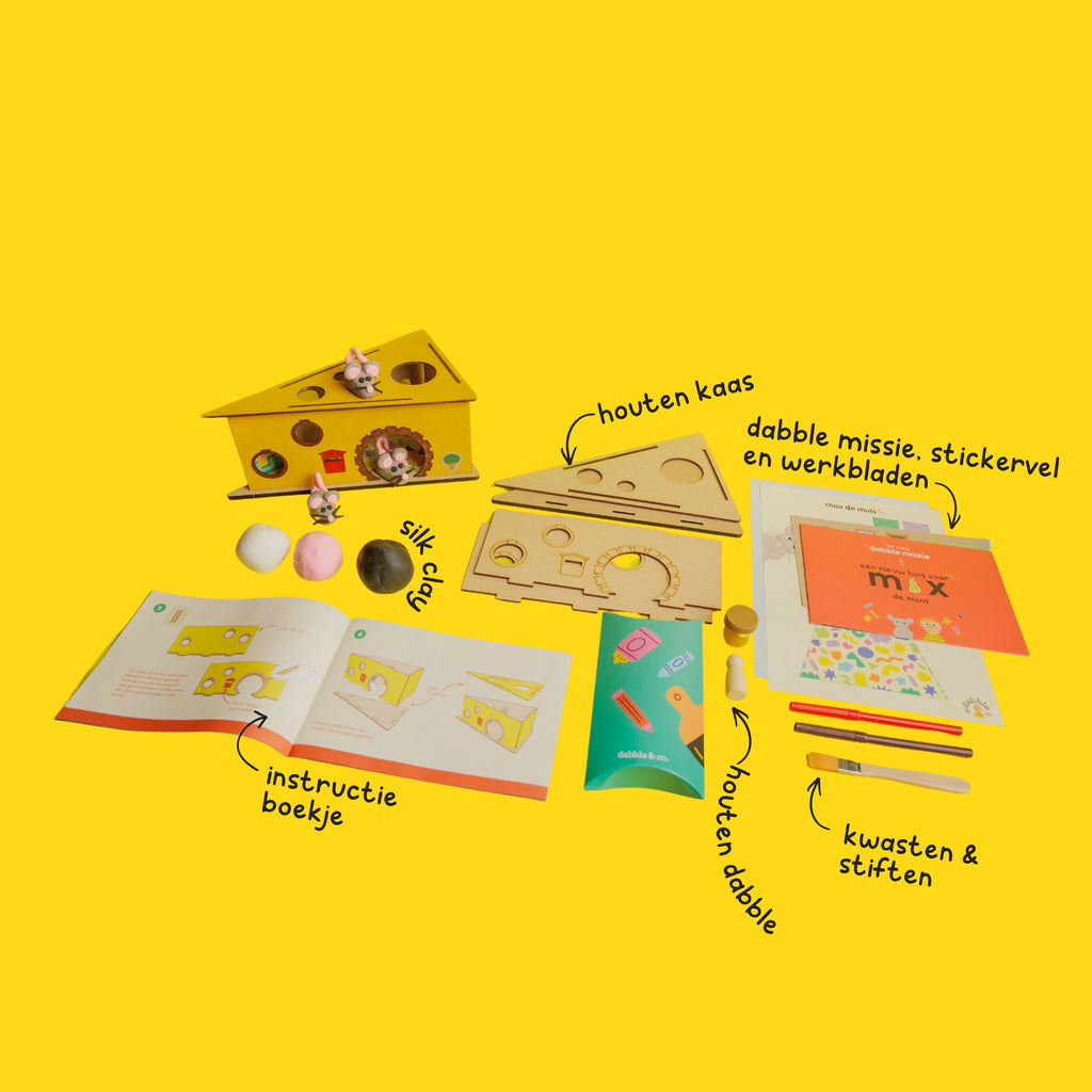 The contents of the Max the Mouse DIY kit: pink, white and black clay, wooden cheese base, and sculpting tools.