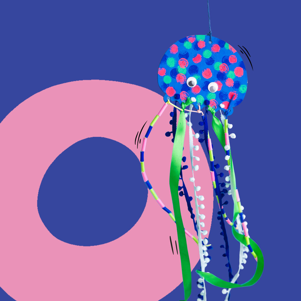 Dabble & Co. Jelly! the Jellyfish craft kit: a wooden jellyfish to paint and decorate with pompom trim, silk ribbons, and a lantern stick.