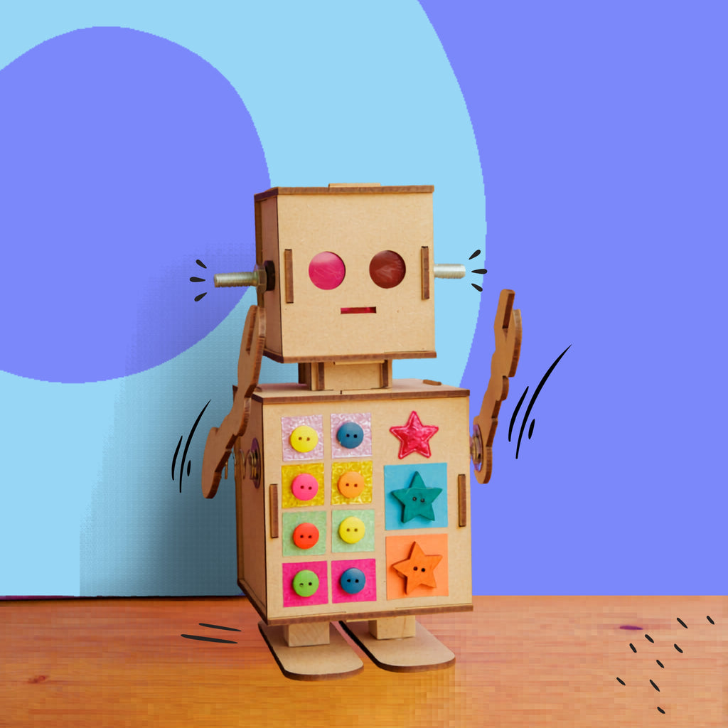 Dabble & Co. Robbie the Robot kids craft kit: a complete DIY set with a wooden robot, metal spring arms, and a built-in light for glowing eyes.