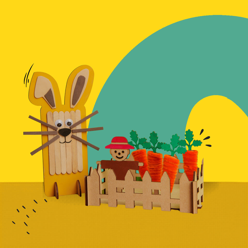 Dabble & Co. Bunny and the Carrot Patch craft kit: a complete DIY set featuring a popsicle stick bunny and a carrot patch made from wooden carrots and orange pipe cleaners.
