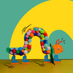 Dabble & Co. The Disco Caterpillar craft kit: a wooden caterpillar on roller skates with interchangeable stands of a leaf and a watermelon.
