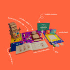 The contents of the Robbie the Robot box, featuring mirror mosaic tiles, rhinestones, glitter paper, and metal springs.