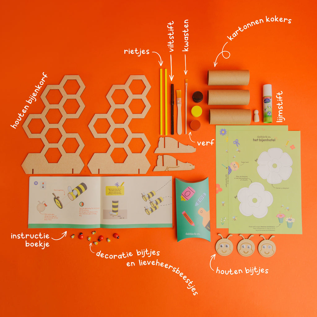 he Bee Hotel craft kit by Dabble & Co. featuring a wooden beehive, miniature bees and ladybugs, and materials to make tube bees.