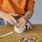 Hand-sculpting a dog bone and a water bowl from air-dry clay, included in the Dabble & Co. set.