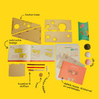 The contents of the Max the Mouse DIY kit: pink, white and black clay, wooden cheese base, and crafting tools.